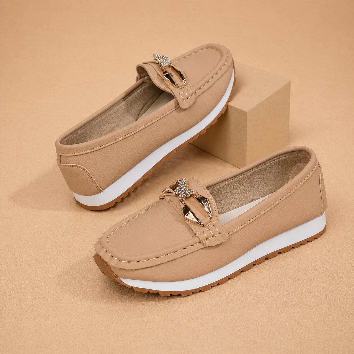 Women's buckle loafers in beige and black, classic slip-on flats