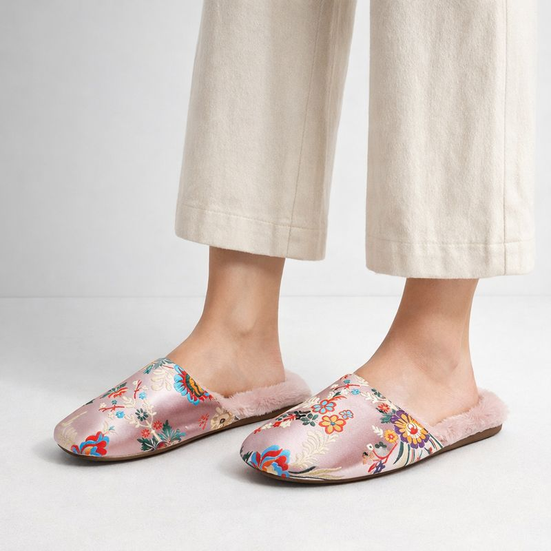 Satin floral slippers with embroidered detailing and soft plush lining, shown in green, pink and black