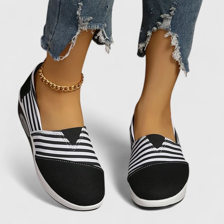Comfortable everyday women's slip-on sneakers shown in blue, black and red