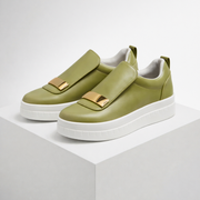 Cushioned platform slip-on shoes shown in green, white and black