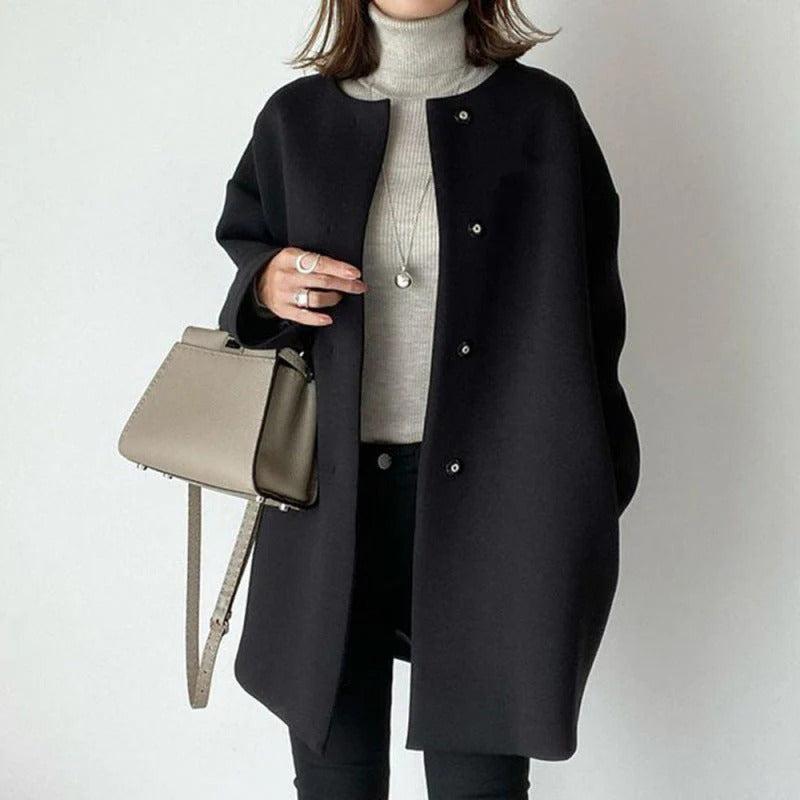 Orla relaxed fit coat shown in a neutral shade, styled for everyday wear