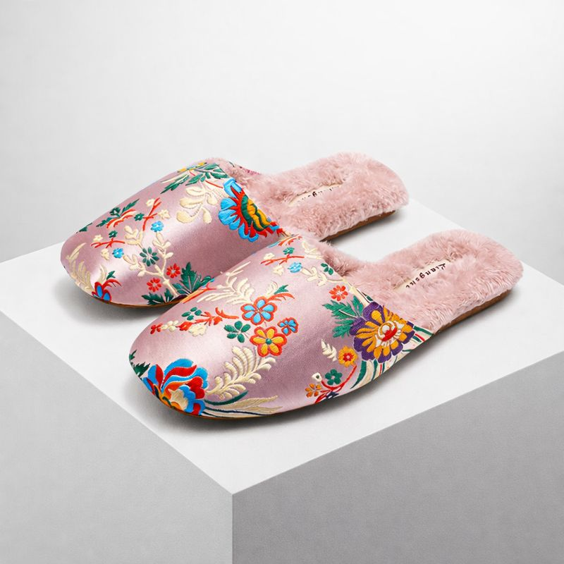 Satin floral slippers with embroidered detailing and soft plush lining, shown in green, pink and black