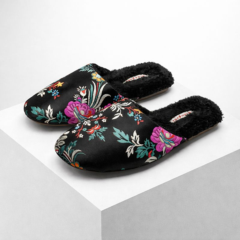 Satin floral slippers with embroidered detailing and soft plush lining, shown in green, pink and black