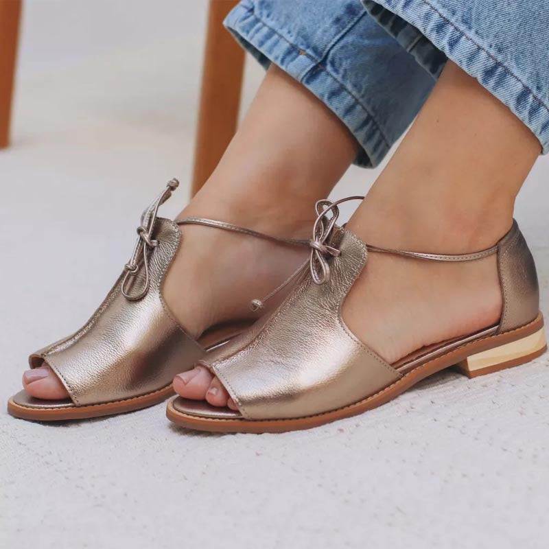 Champagne strap-style sandals for women shown from the side