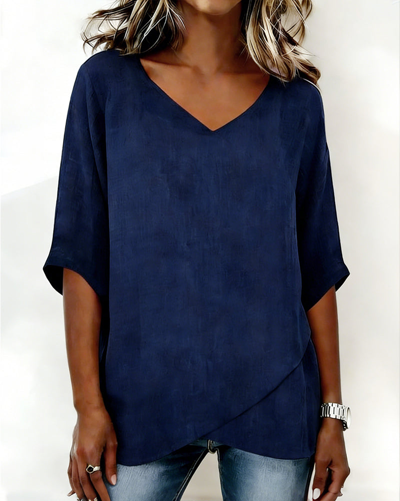 Donna irregular V-neck top shown in blue, white and navy blue