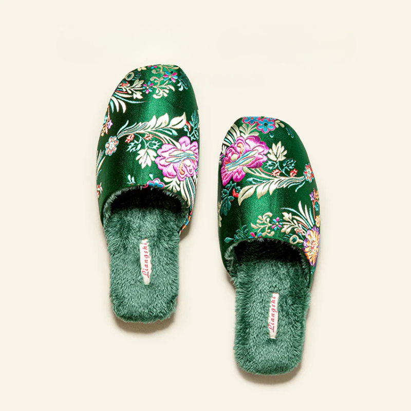 Satin floral slippers with embroidered detailing and soft plush lining, shown in green, pink and black