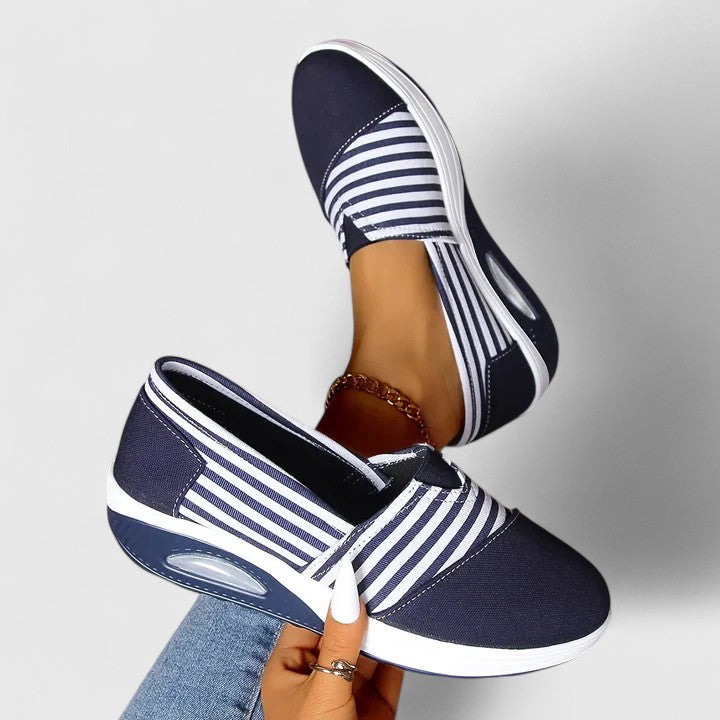 Comfortable everyday women's slip-on sneakers shown in blue, black and red