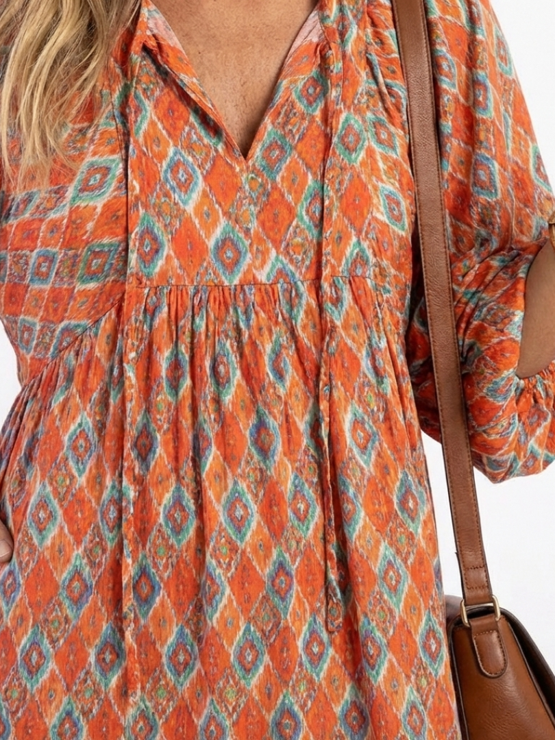 Beige geometric print v-neck tiered midi dress with relaxed silhouette and pockets