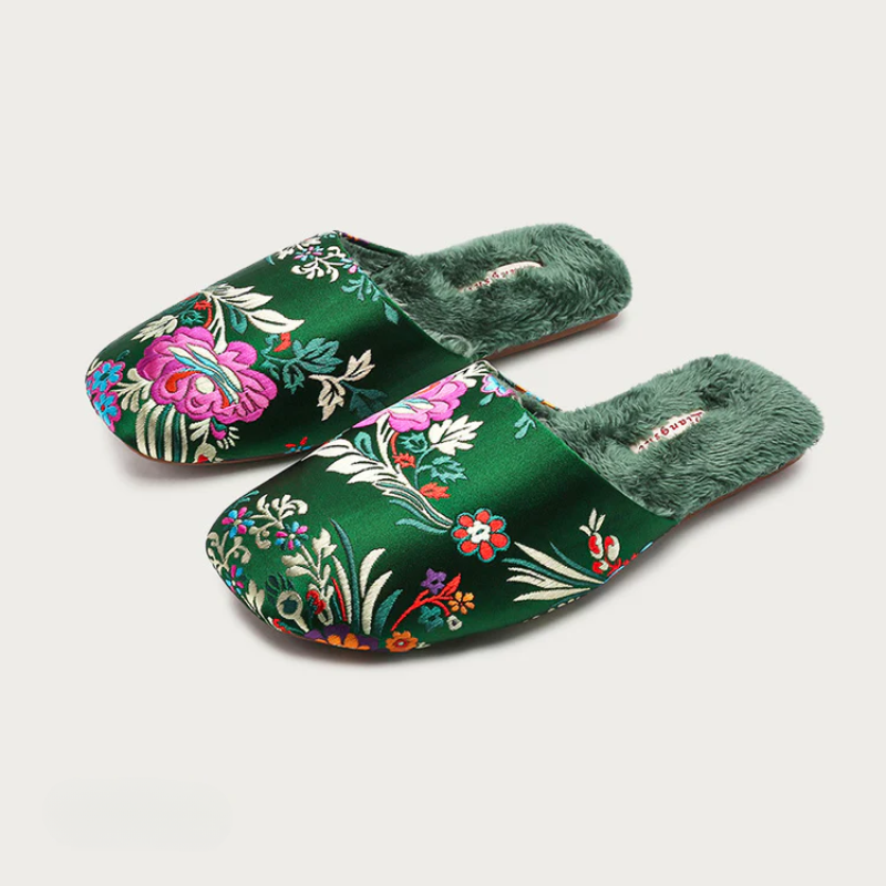 Satin floral slippers with embroidered detailing and soft plush lining, shown in green, pink and black