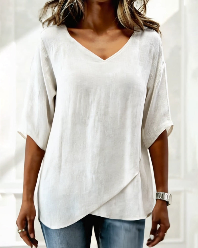 Donna irregular V-neck top shown in blue, white and navy blue