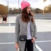 Amara long wool coat shown in a tailored, elegant silhouette for everyday layering