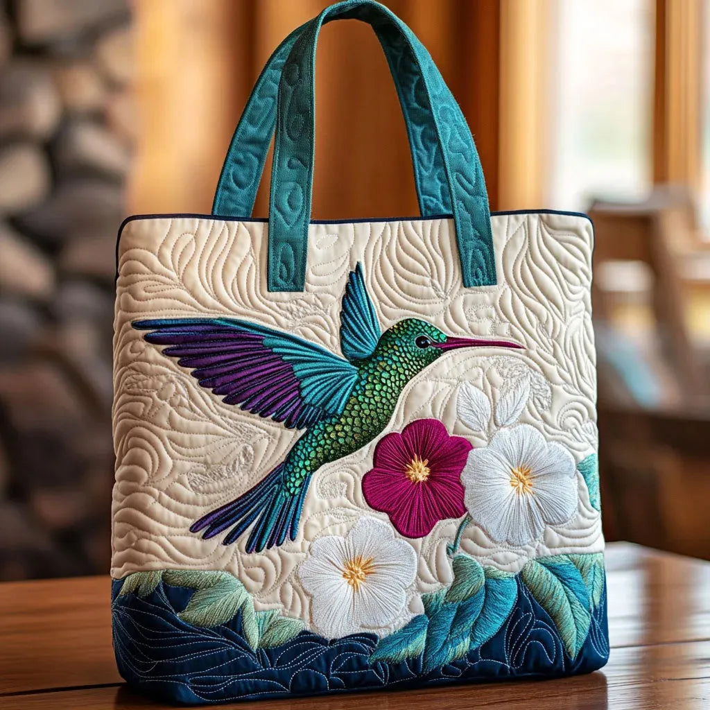 Quilted handmade bag with hummingbird and white flower design, shown in two sizes