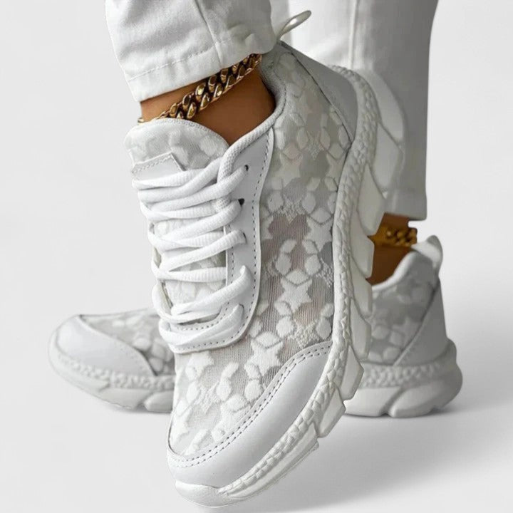 White cushioned lace-up sneakers with a grippy sole for everyday wear