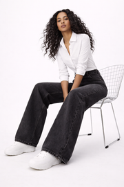Ines black dark flare jeans shown in a flattering full-length flare cut