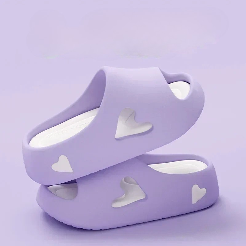 Heart-detail cushioned platform slides shown in purple, khaki, black and white