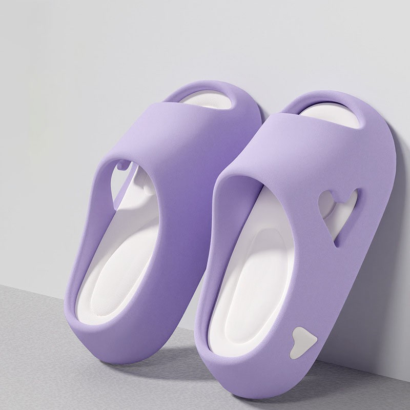 Heart-detail cushioned platform slides shown in purple, khaki, black and white