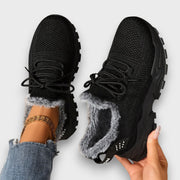 Lace-up insulated winter sneakers with a lightweight sole, shown in a casual everyday style