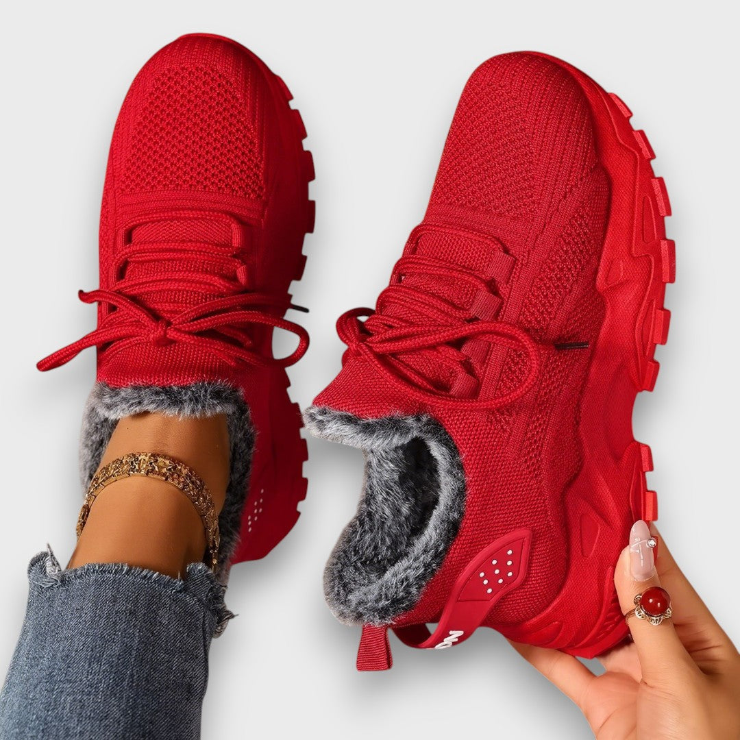 Lace-up insulated winter sneakers with a lightweight sole, shown in a casual everyday style