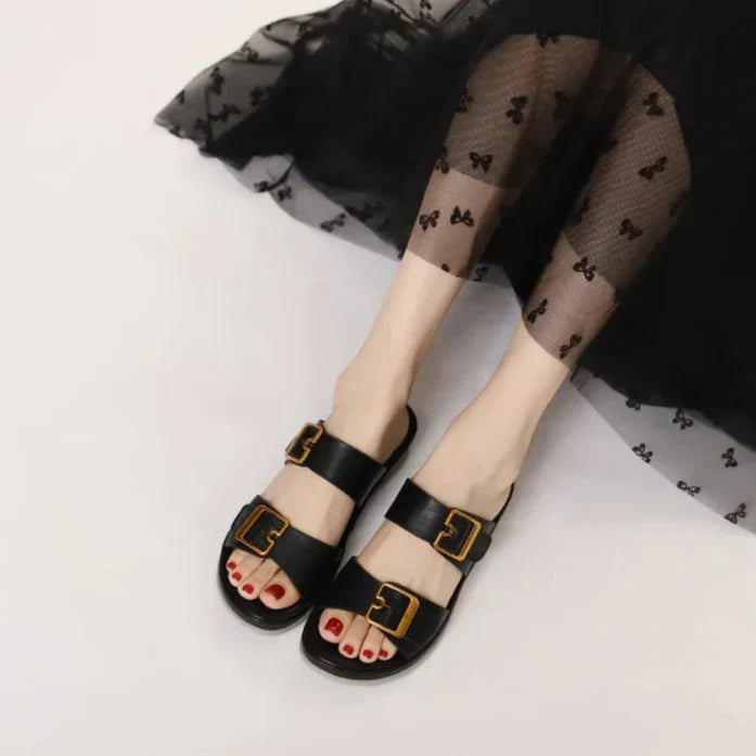 Women's cushioned double-strap slide slippers with gold-tone buckles in a neutral tone
