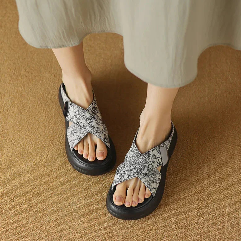 Floral textured platform sandals with wide crisscross velcro straps and elevated sole