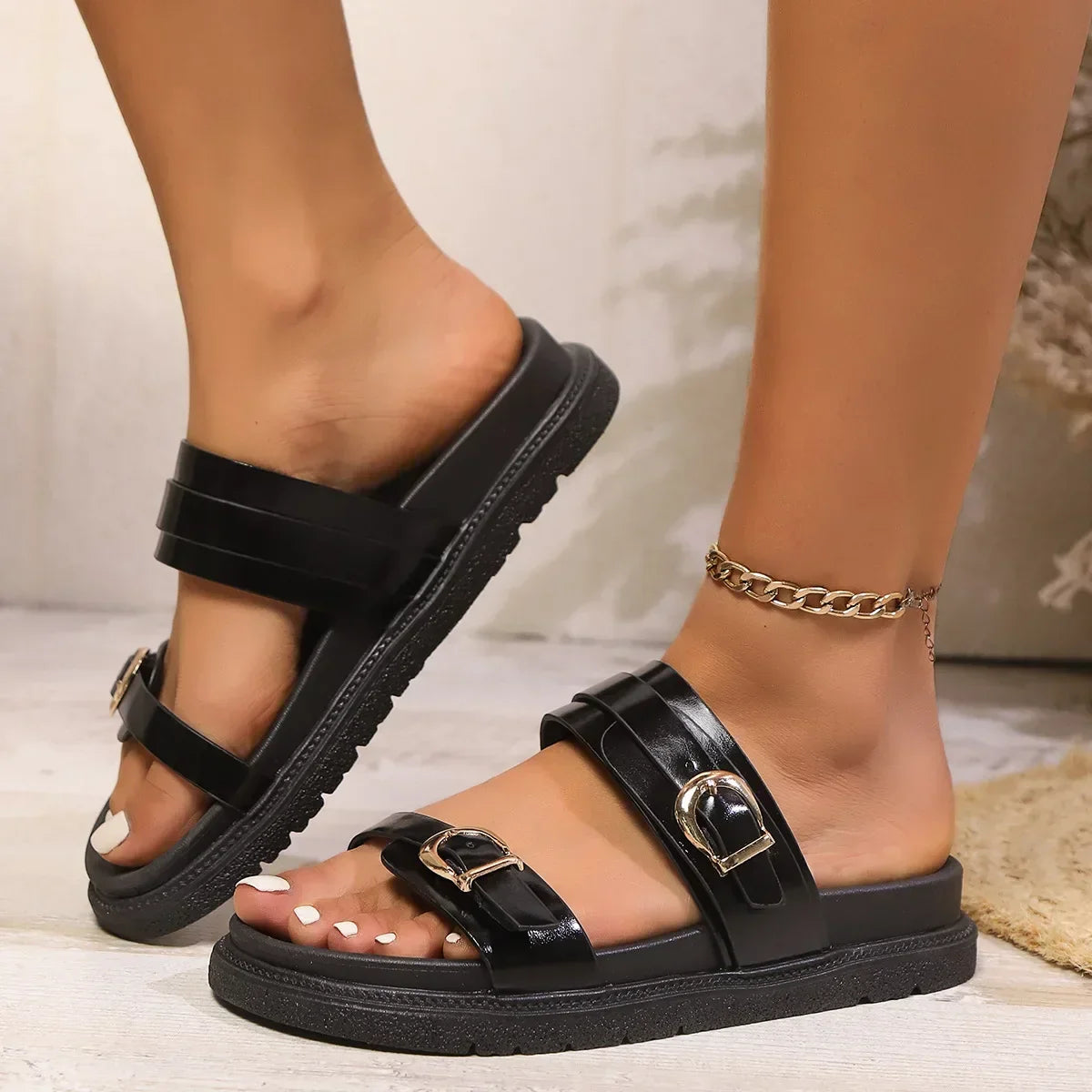Naomi leather slide sandals with twin gold-tone buckles and cushioned sole in black and brown