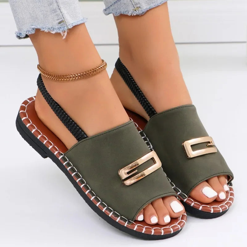Flat sandals with gold buckle accent and contrast stitching in neutral tones