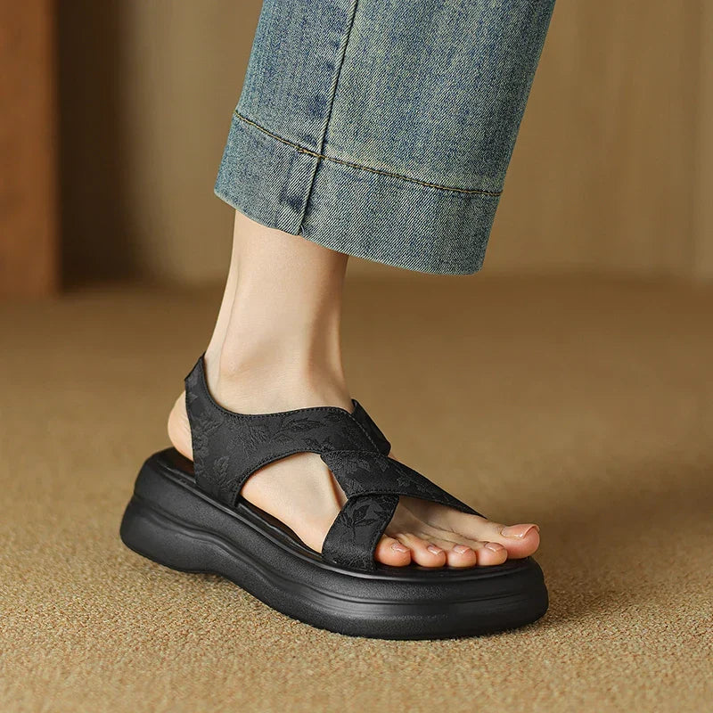 Floral embossed crisscross platform sandals with chunky sole in black