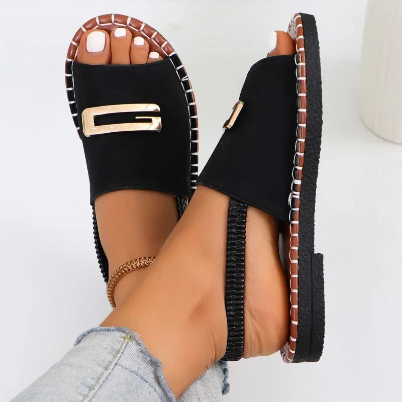 Flat sandals with gold buckle accent and contrast stitching in neutral tones