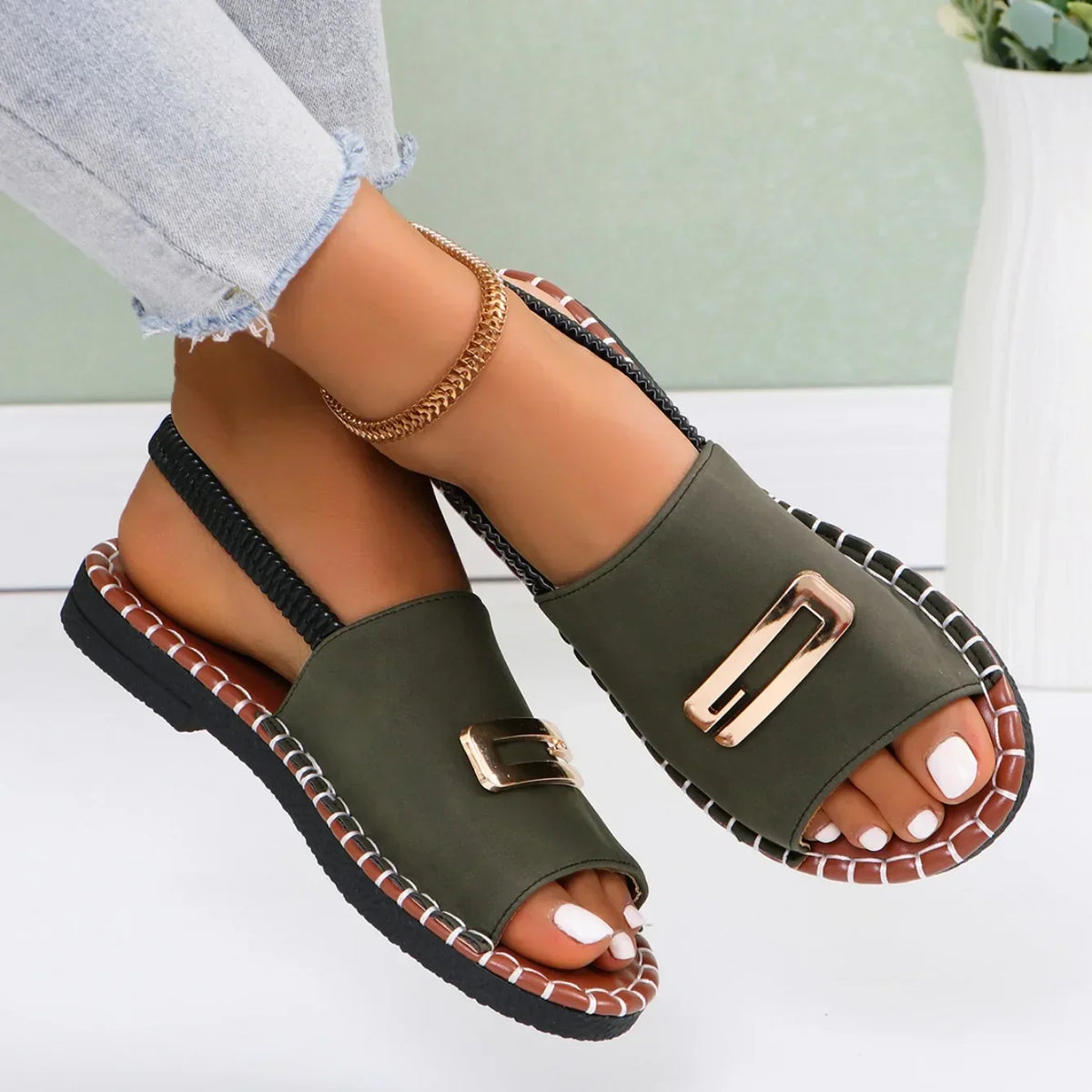 Flat sandals with gold buckle accent and contrast stitching in neutral tones