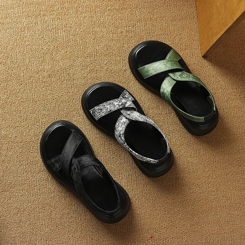 Floral embossed crisscross platform sandals with chunky sole in black