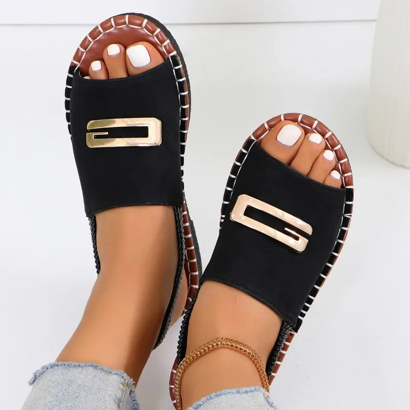 Flat sandals with gold buckle accent and contrast stitching in neutral tones