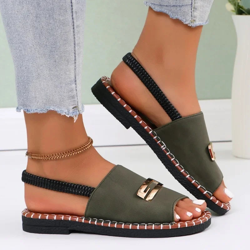 Flat sandals with gold buckle accent and contrast stitching in neutral tones