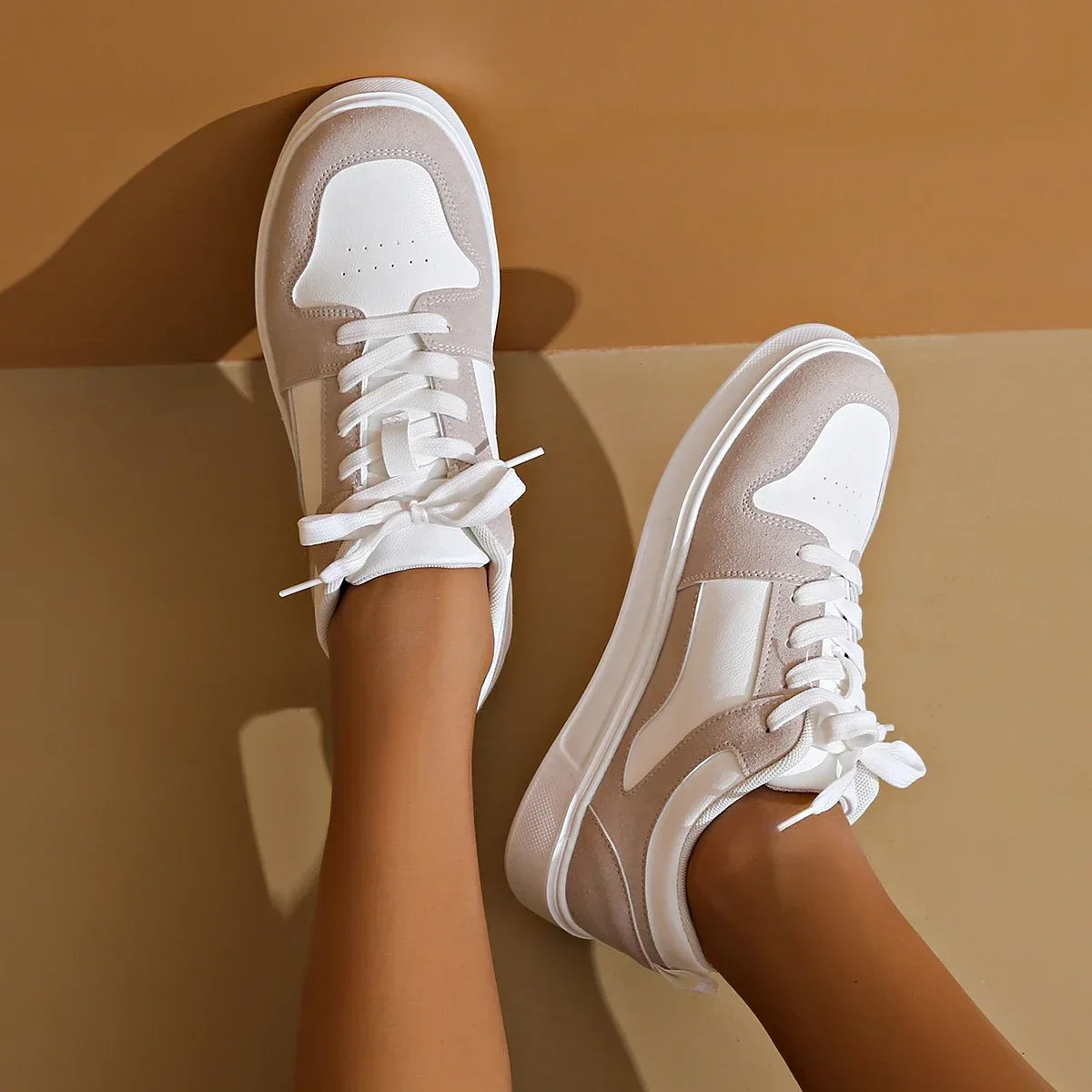 Cushioned low-top lace-up sneakers with breathable panels and treaded sole