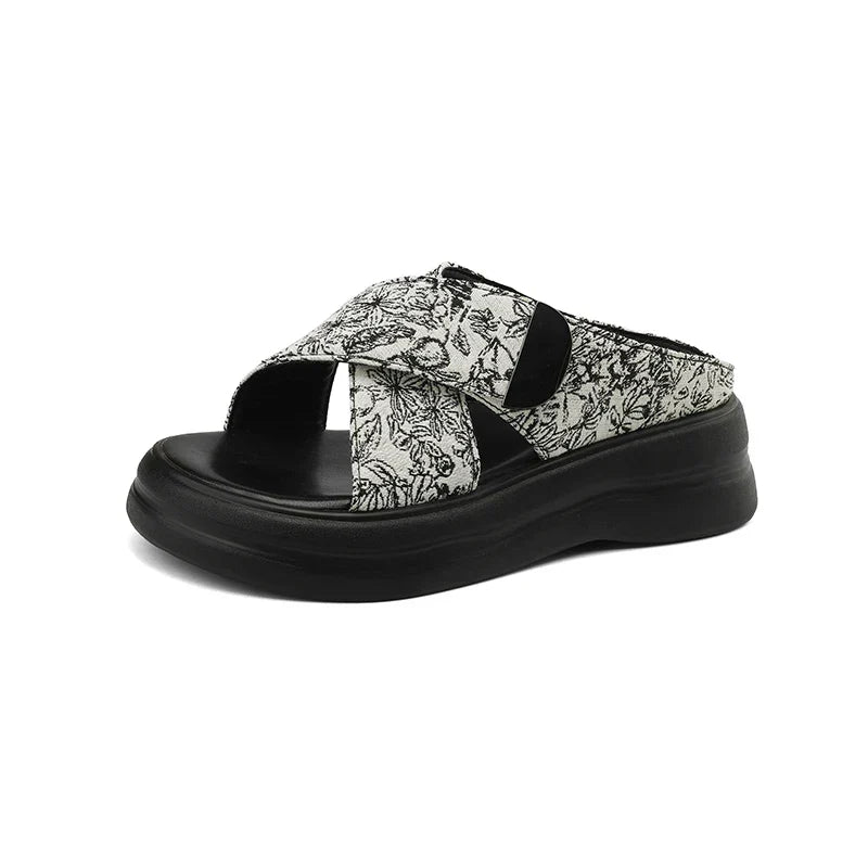 Floral textured platform sandals with wide crisscross velcro straps and elevated sole