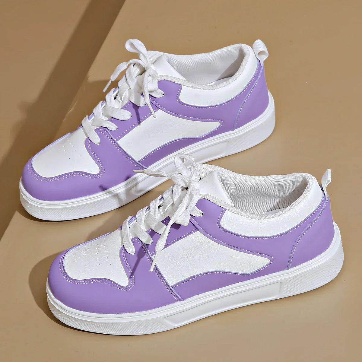 Cushioned low-top lace-up sneakers with breathable panels and treaded sole