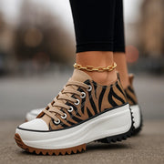 Imogen Rise platform sneakers shown in tiger print, classic black, white snow and light tan