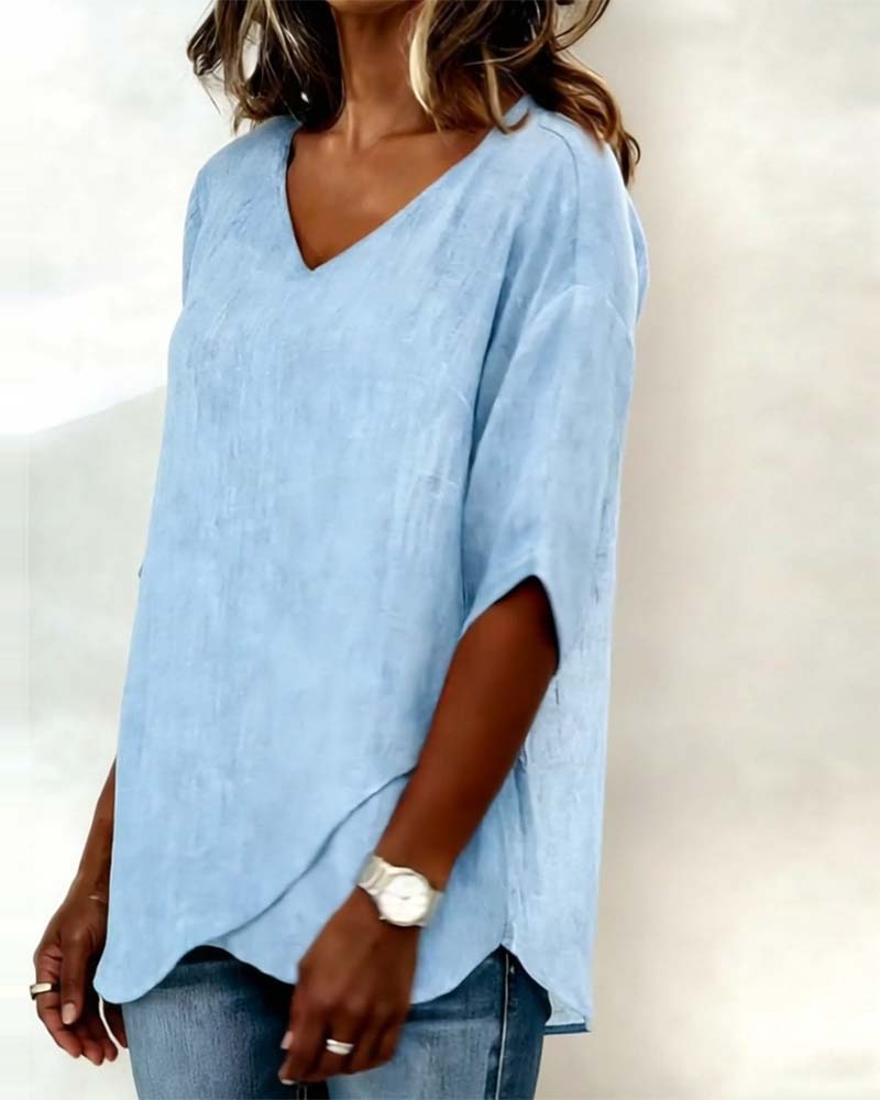 Donna irregular V-neck top shown in blue, white and navy blue