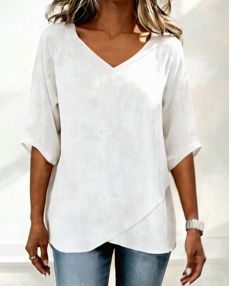 Donna irregular V-neck top shown in blue, white and navy blue