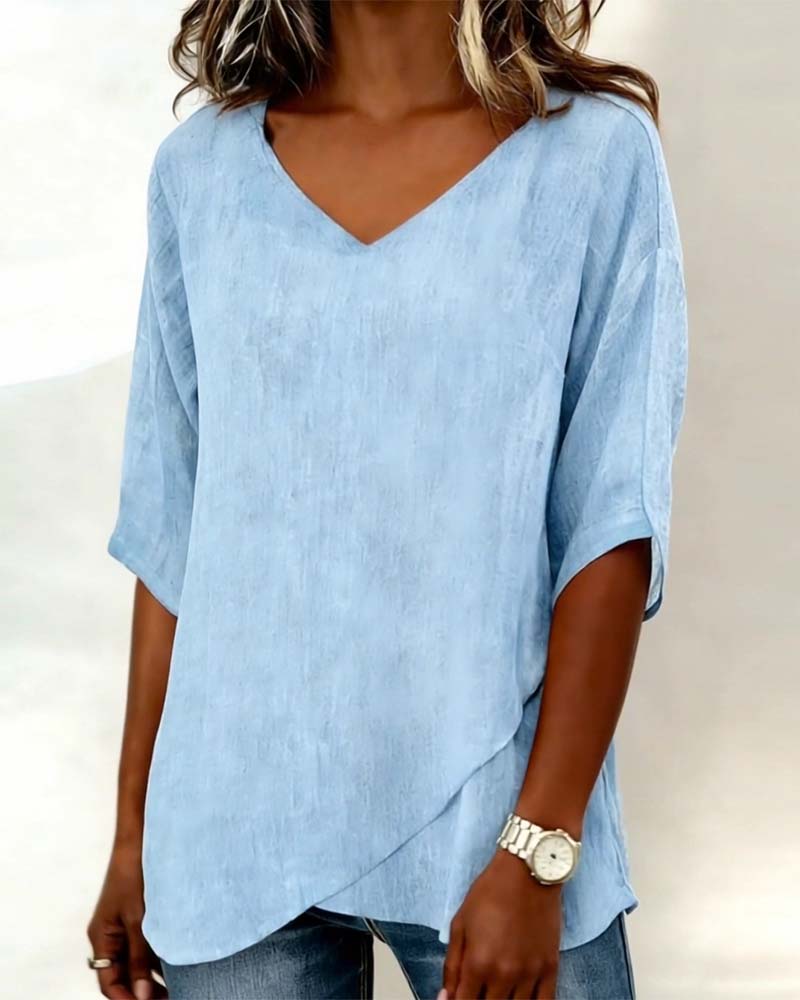 Donna irregular V-neck top shown in blue, white and navy blue