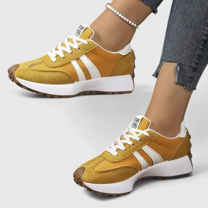 Women's everyday lace-up comfort sneakers shown in white, green, black and yellow