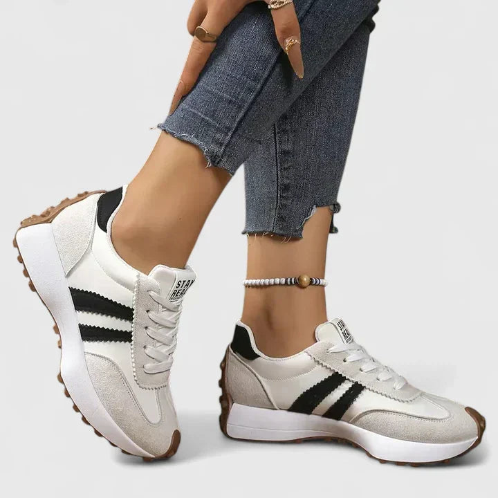 Women's everyday lace-up comfort sneakers shown in white, green, black and yellow