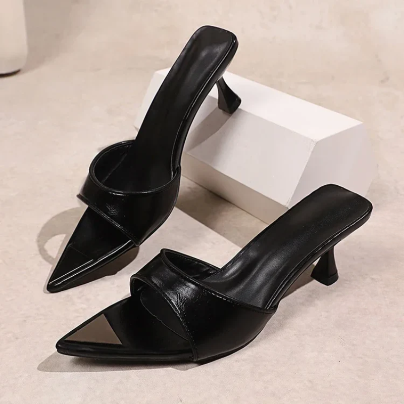 Pointed-toe mule with flared low heel and signature studs in leopard and black