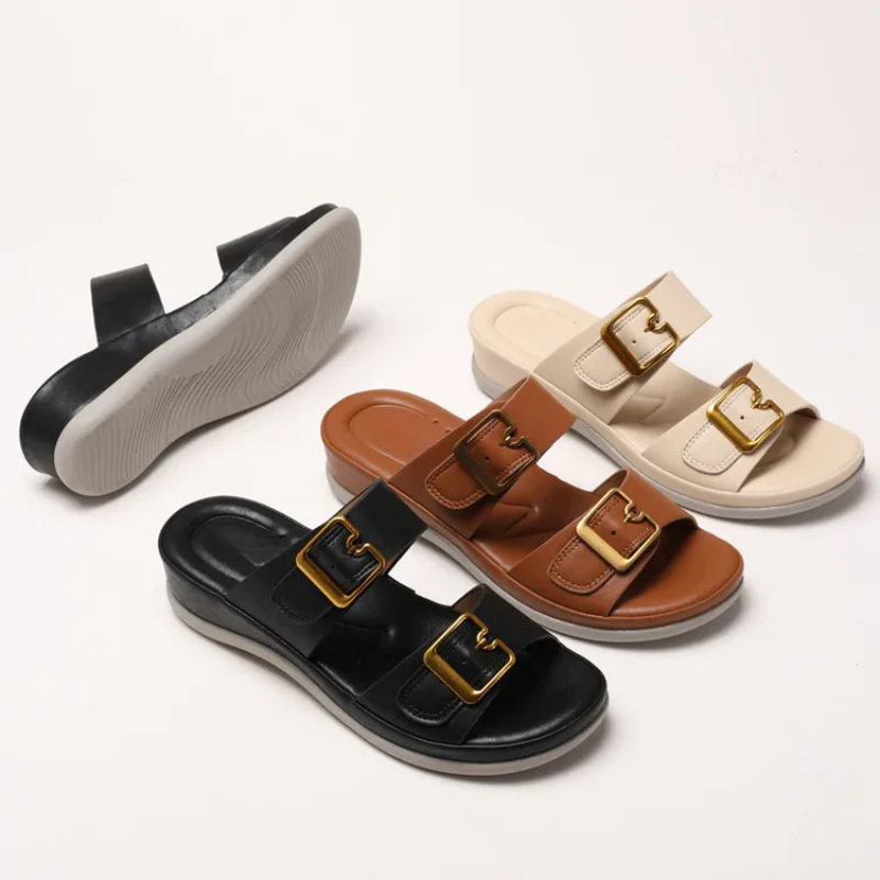 Women's cushioned double-strap slide slippers with gold-tone buckles in a neutral tone