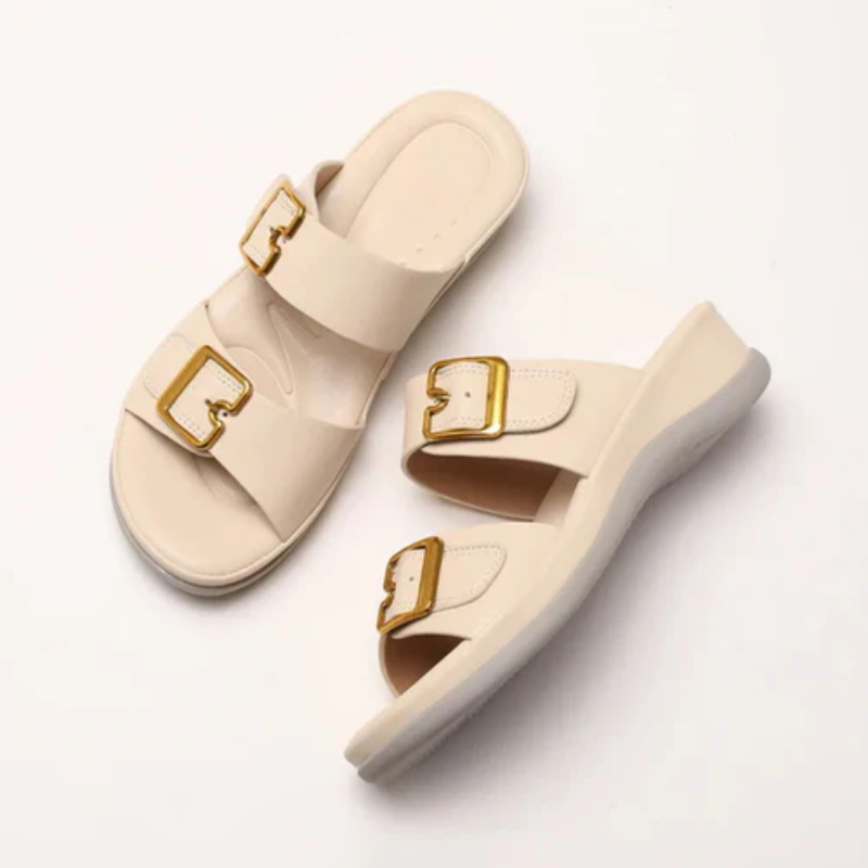 Women's cushioned double-strap slide slippers with gold-tone buckles in a neutral tone