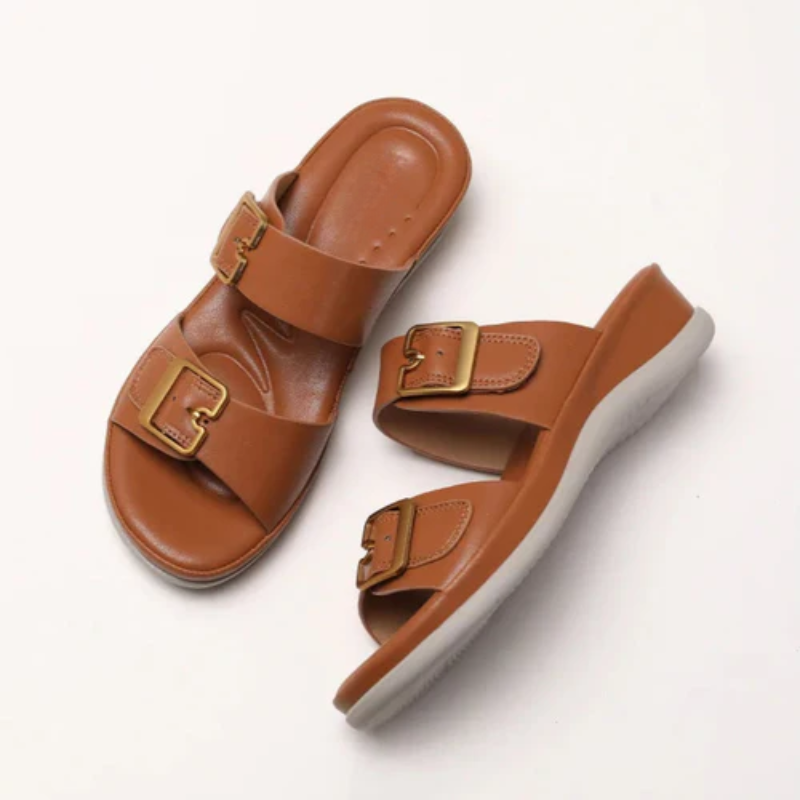 Women's cushioned double-strap slide slippers with gold-tone buckles in a neutral tone