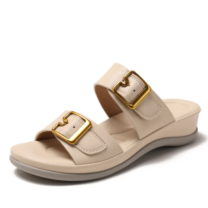 Women's cushioned double-strap slide slippers with gold-tone buckles in a neutral tone